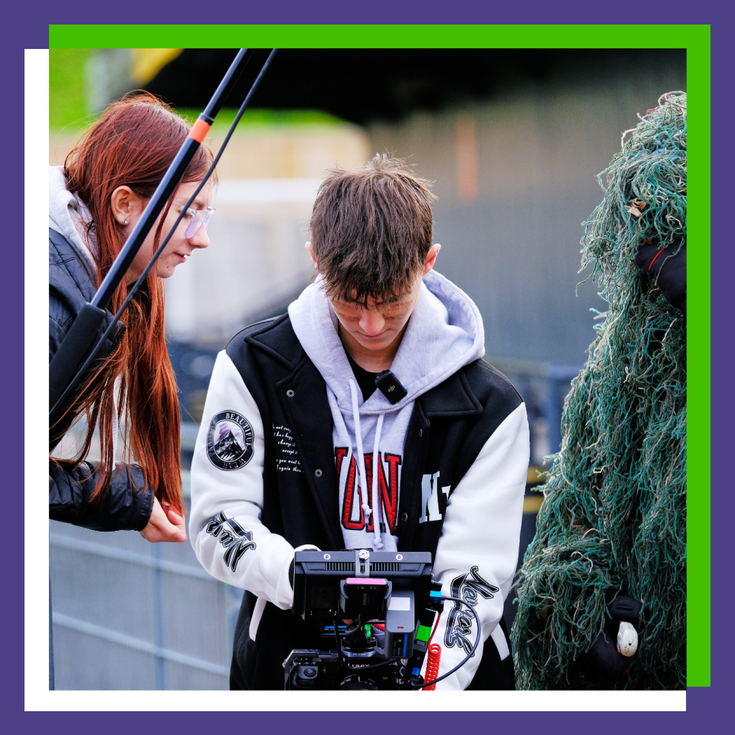 Three people operate a camera