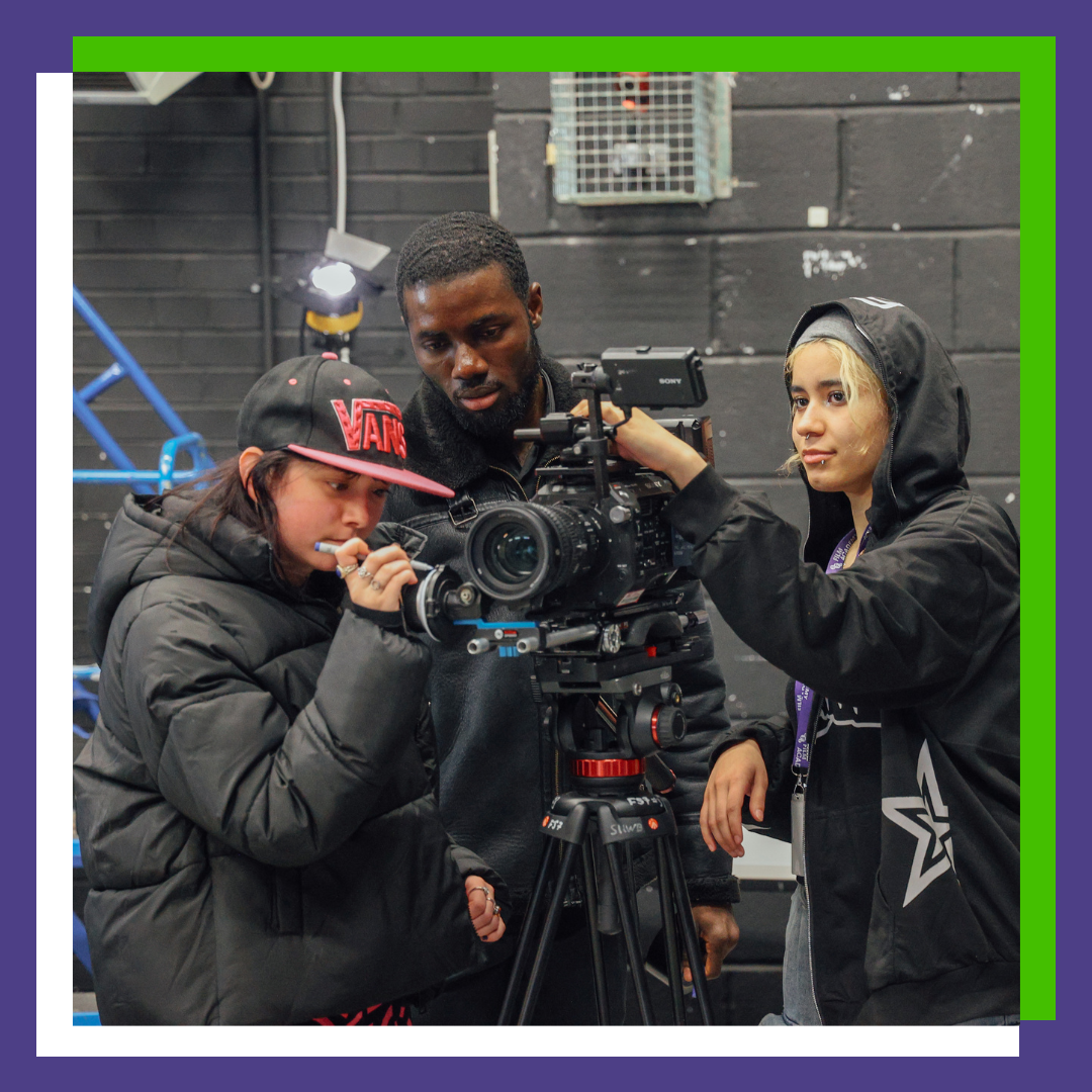 Three people operate a camera