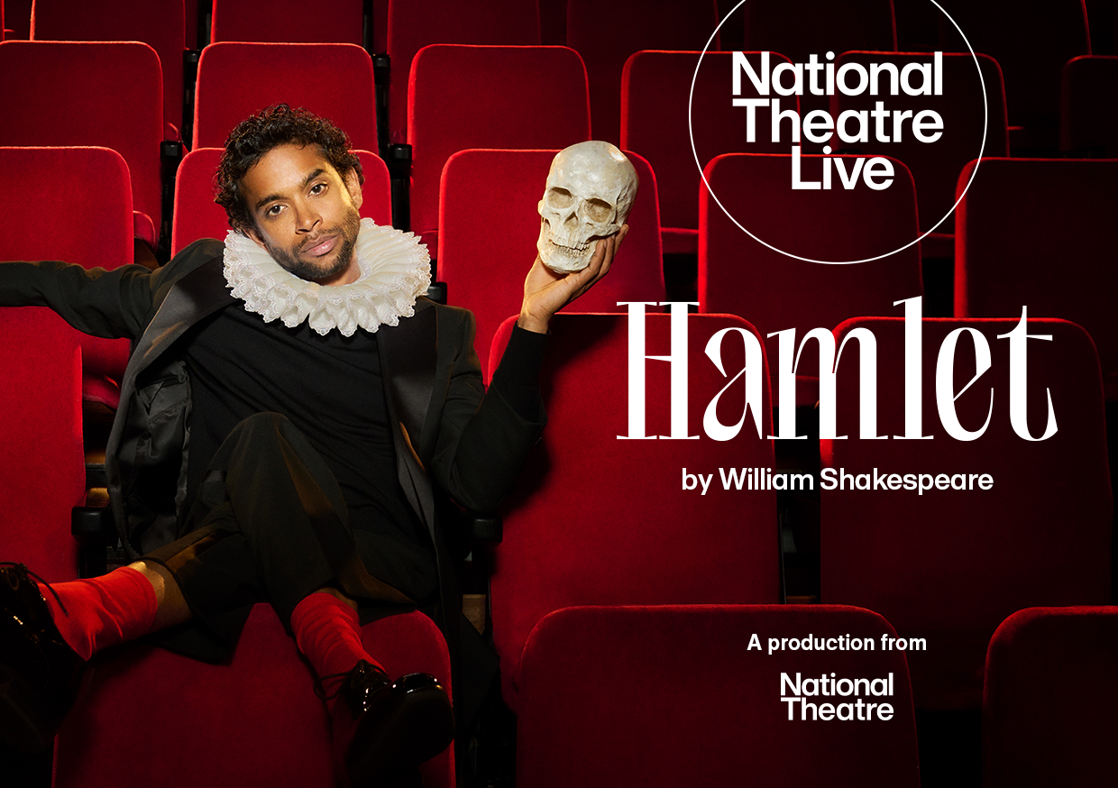 Man dressed as Hamlet holds a skull.