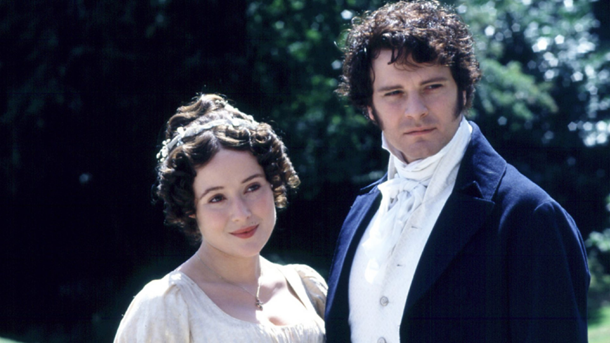 a man and a woman in period dress stand together.